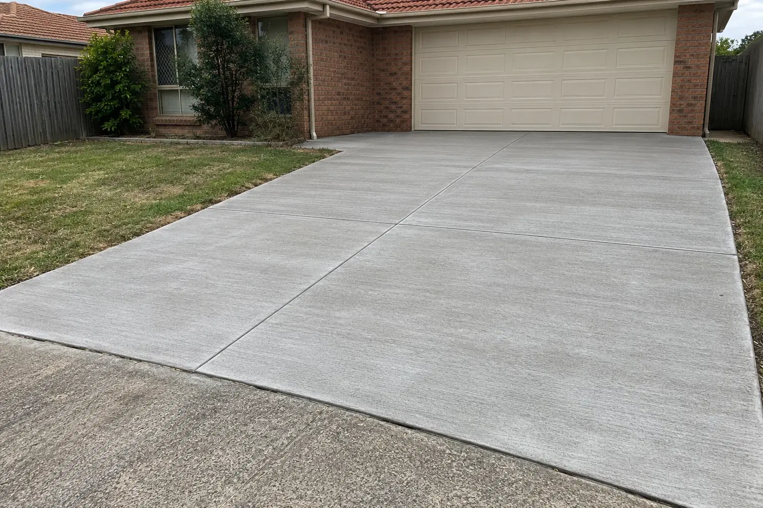 Design concept of a broom-finished concrete driveway at a brick home